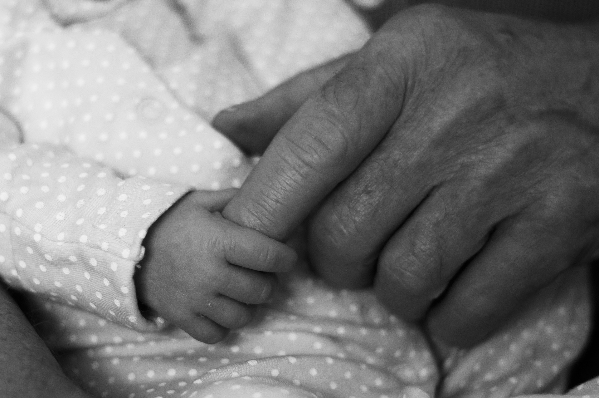 child holding parent's finger